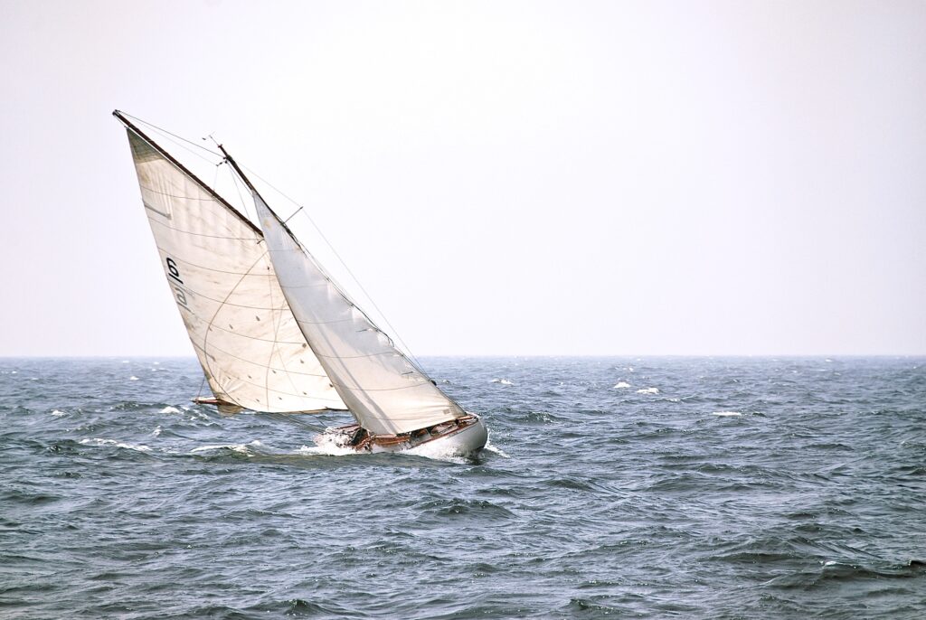 sailboat heeling to left - Navigating The Difficult Channels Of The Real Estate Industry