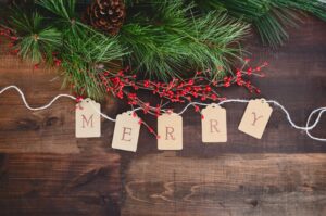 Christmas greenery and berries wtih words Merry in wooden tags on front - Christmas Decor Inspiration